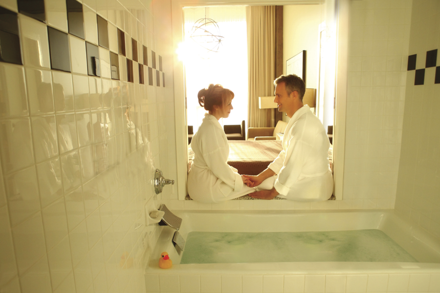 Wink Wink Special Hotel Offerings - Pictures shows a couple gazing into each other's eyes next to a bubblebath.